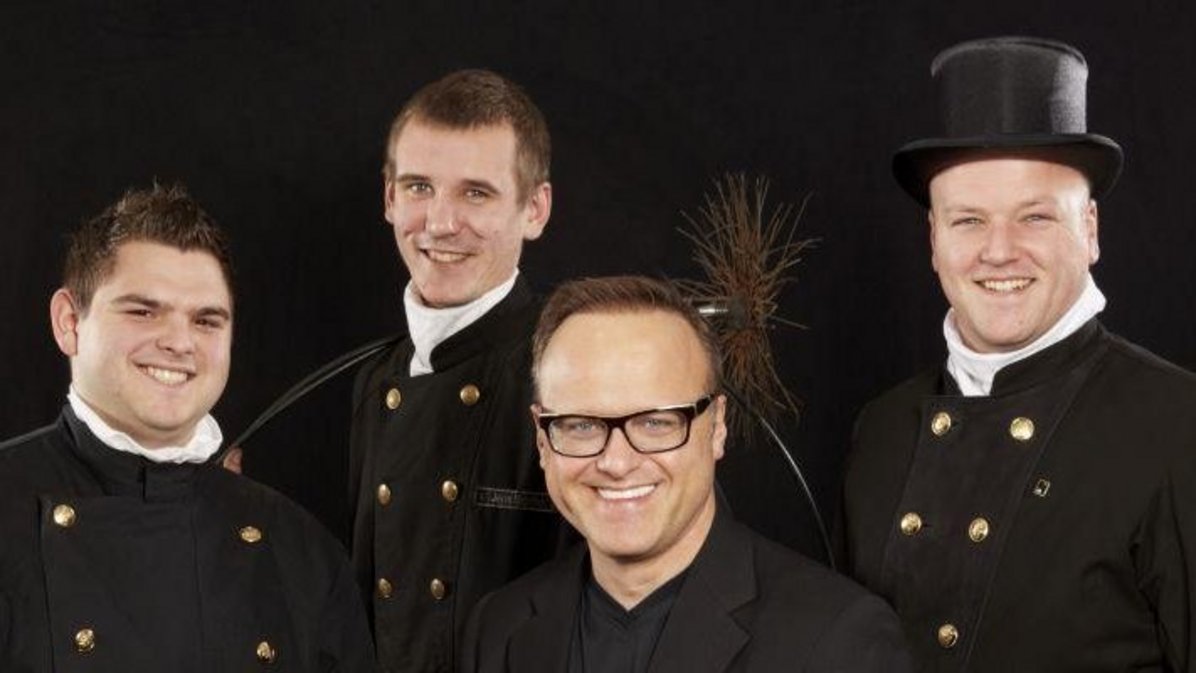 Bild vom Schornsteinfeger Kopf und sein Team